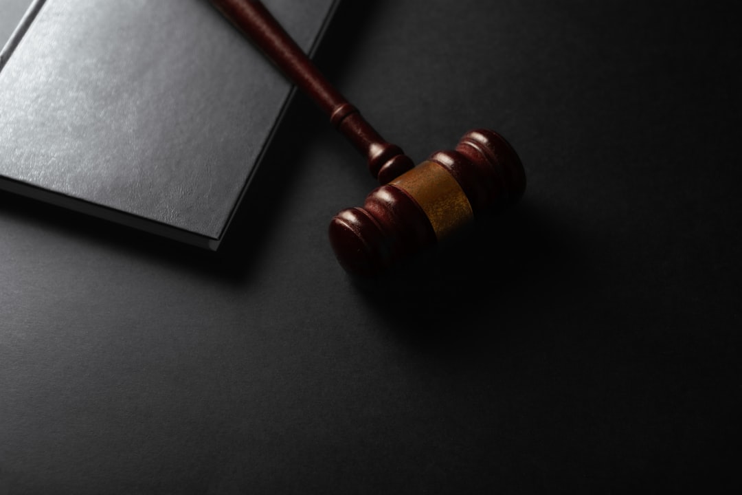 Judge gavel and law book on black background